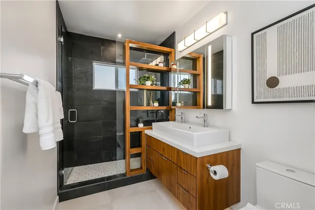 a bathroom with a sink a mirror and a potted plant