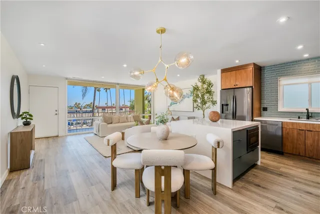 a kitchen with kitchen island wooden floors and white appliances