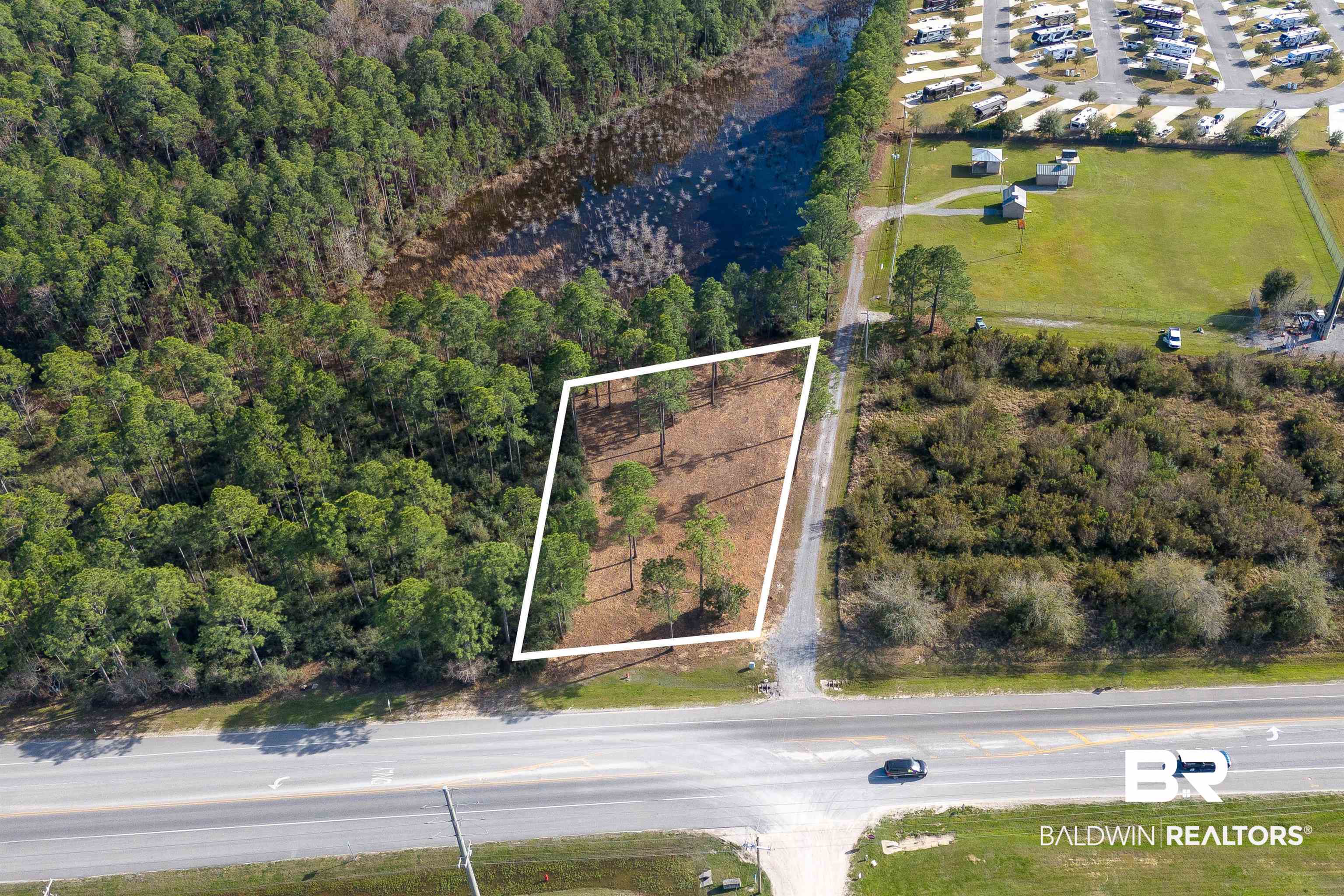 0 Canal Road Orange Beach, AL 36561 - Photo 21 of 25 Bird's eye view featuring a wooded view