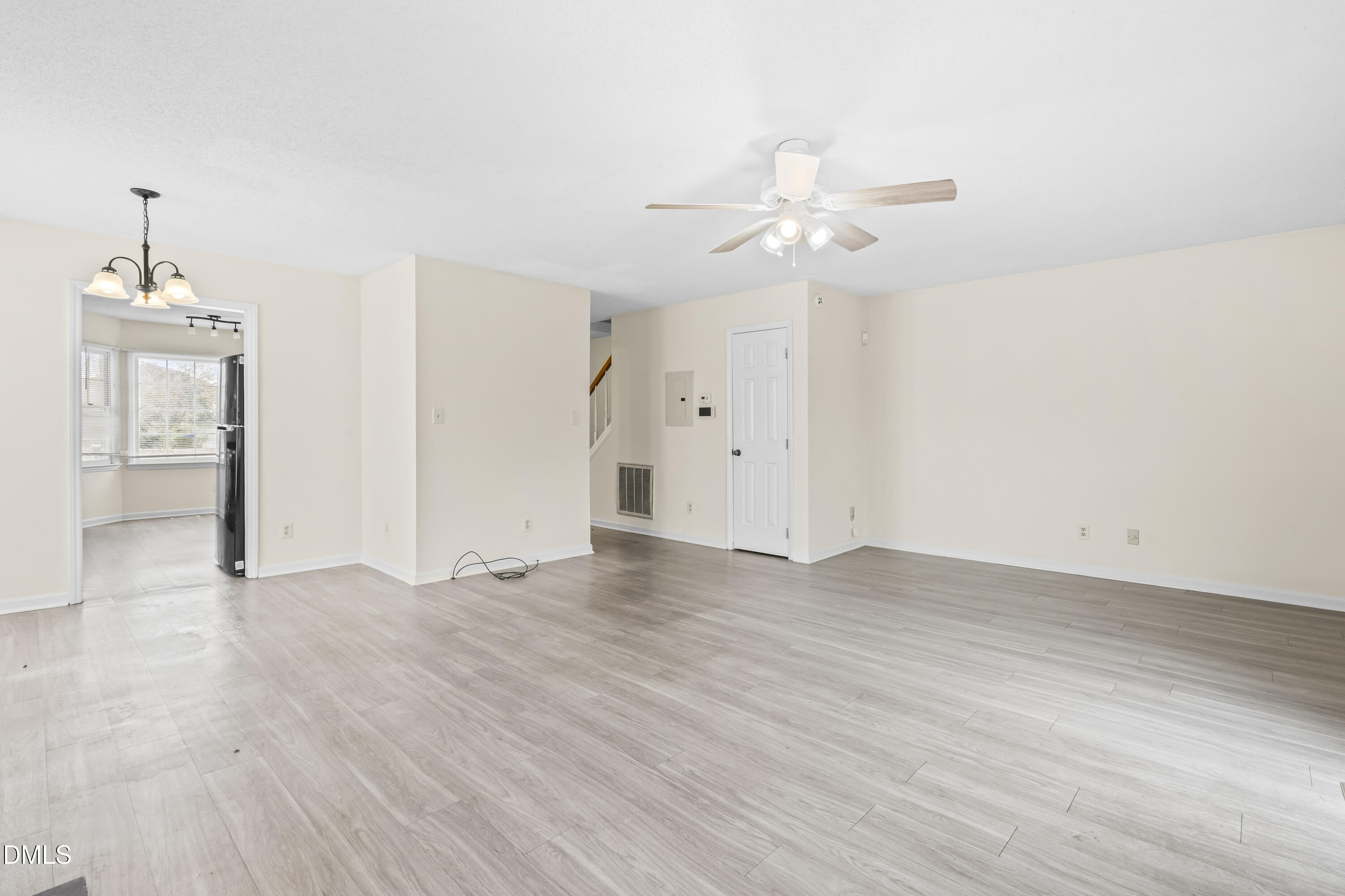 8031 Perry Creek Road Raleigh, NC 27616 - Photo 14 of 28 an empty room with wooden floor and ceiling fan