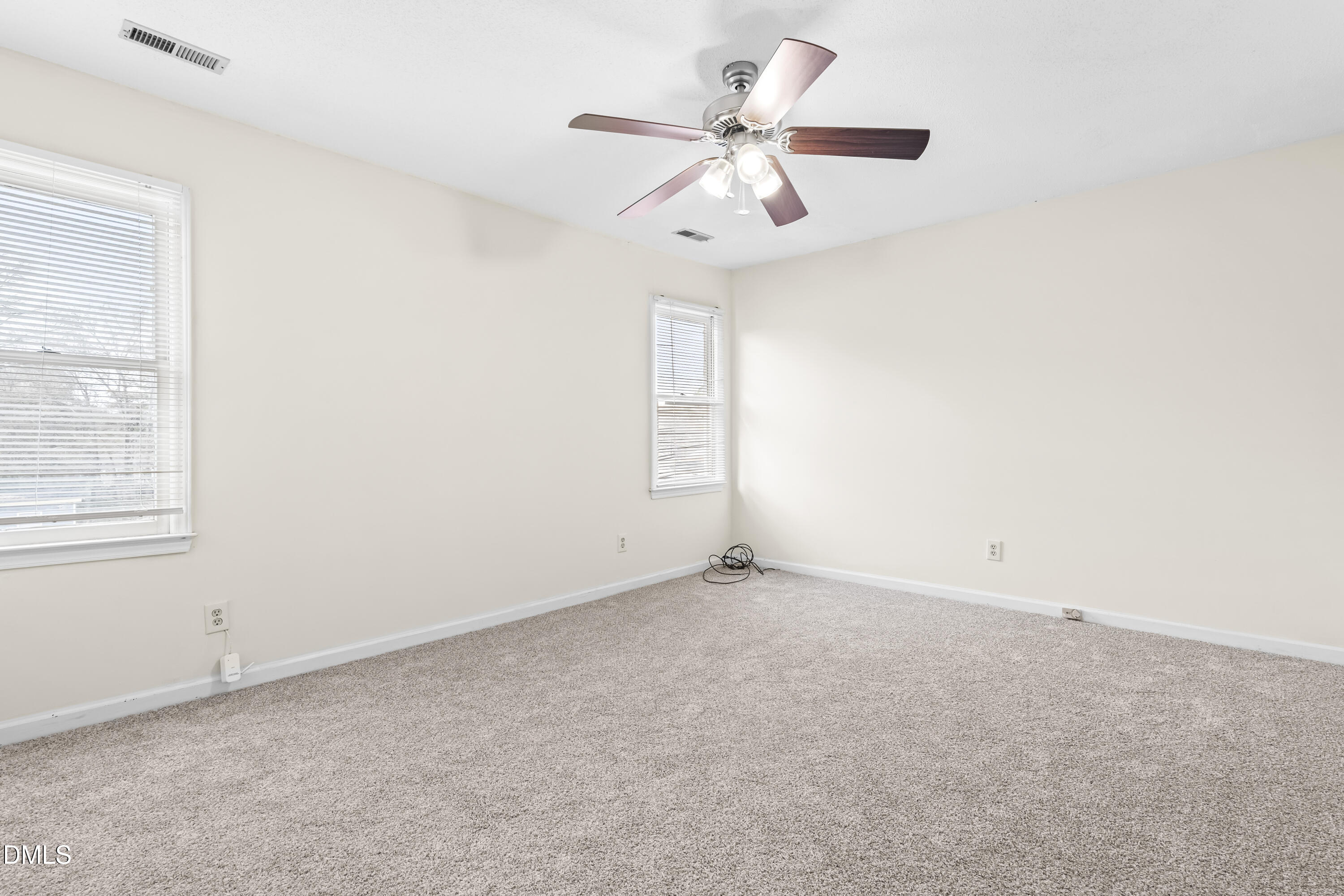 8031 Perry Creek Road Raleigh, NC 27616 - Photo 17 of 28 an empty room with a window and a fan