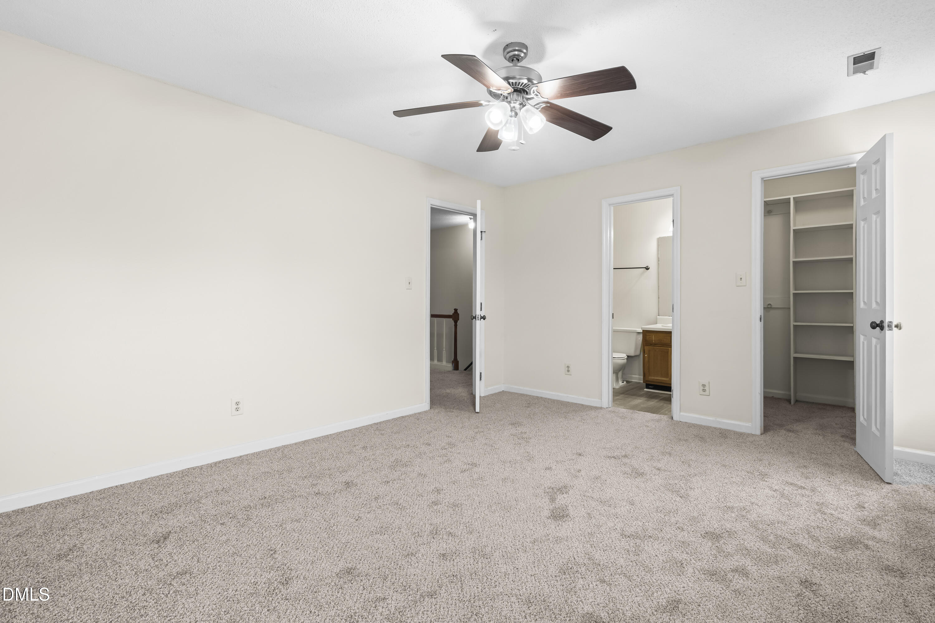 8031 Perry Creek Road Raleigh, NC 27616 - Photo 18 of 28 an empty room with closet and a ceiling fan