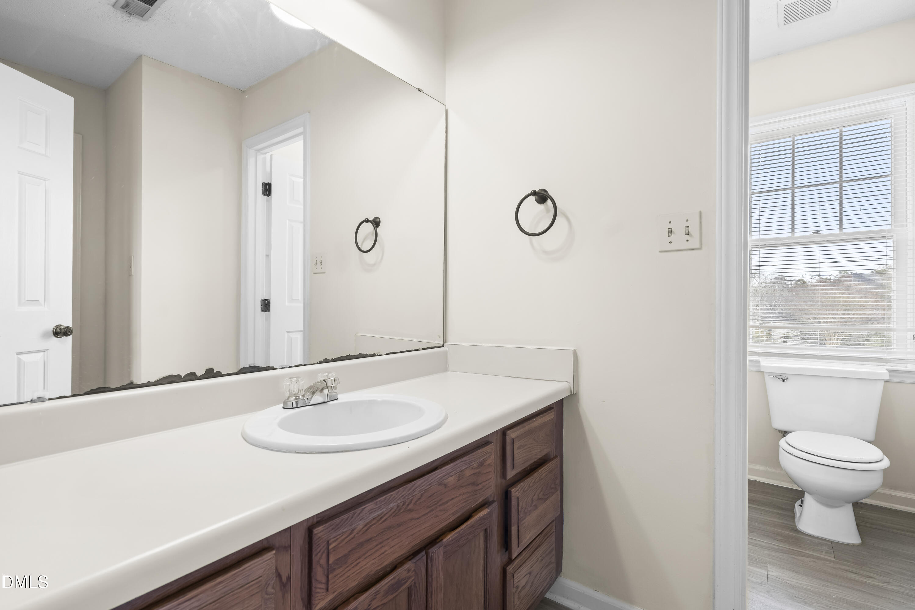 8031 Perry Creek Road Raleigh, NC 27616 - Photo 21 of 28 a bathroom with a sink toilet and vanity