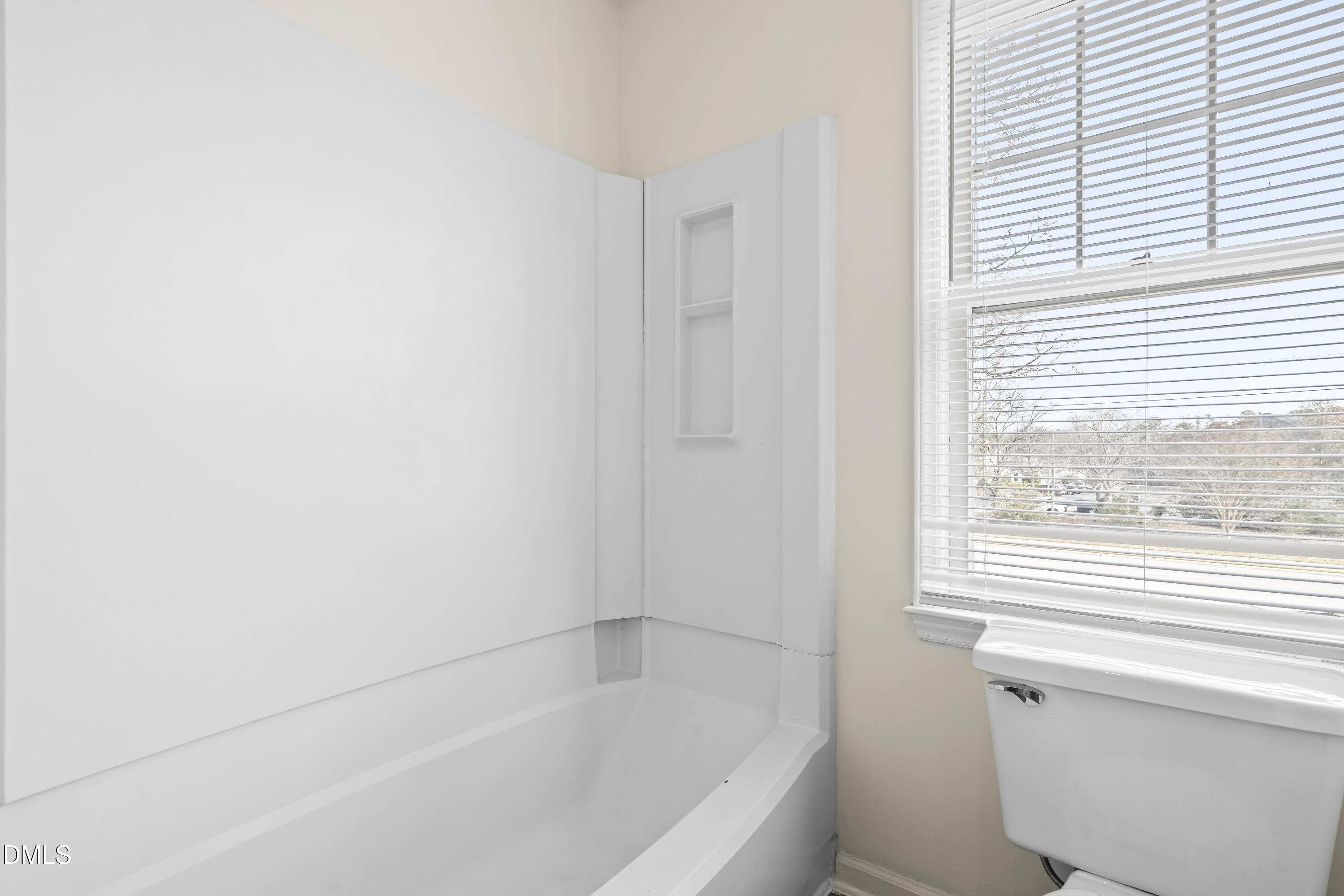 8031 Perry Creek Road Raleigh, NC 27616 - Photo 22 of 28 a bathroom with a bathtub and a window