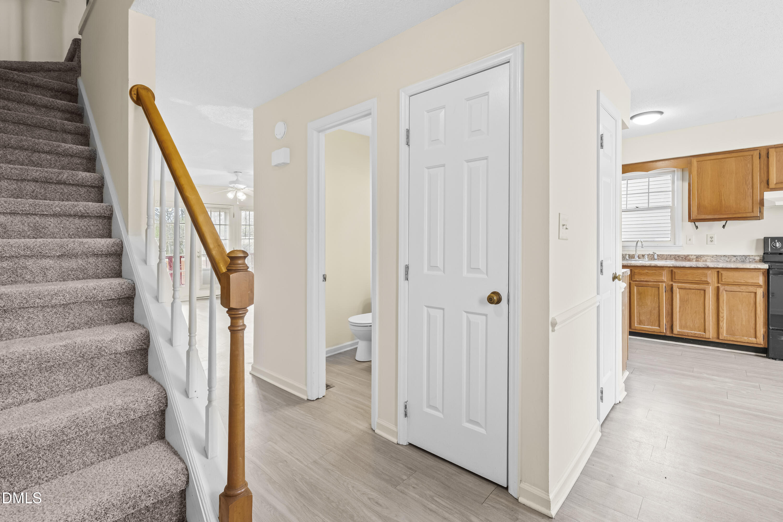 8031 Perry Creek Road Raleigh, NC 27616 - Photo 4 of 28 a view of a hallway with wooden floor and staircase