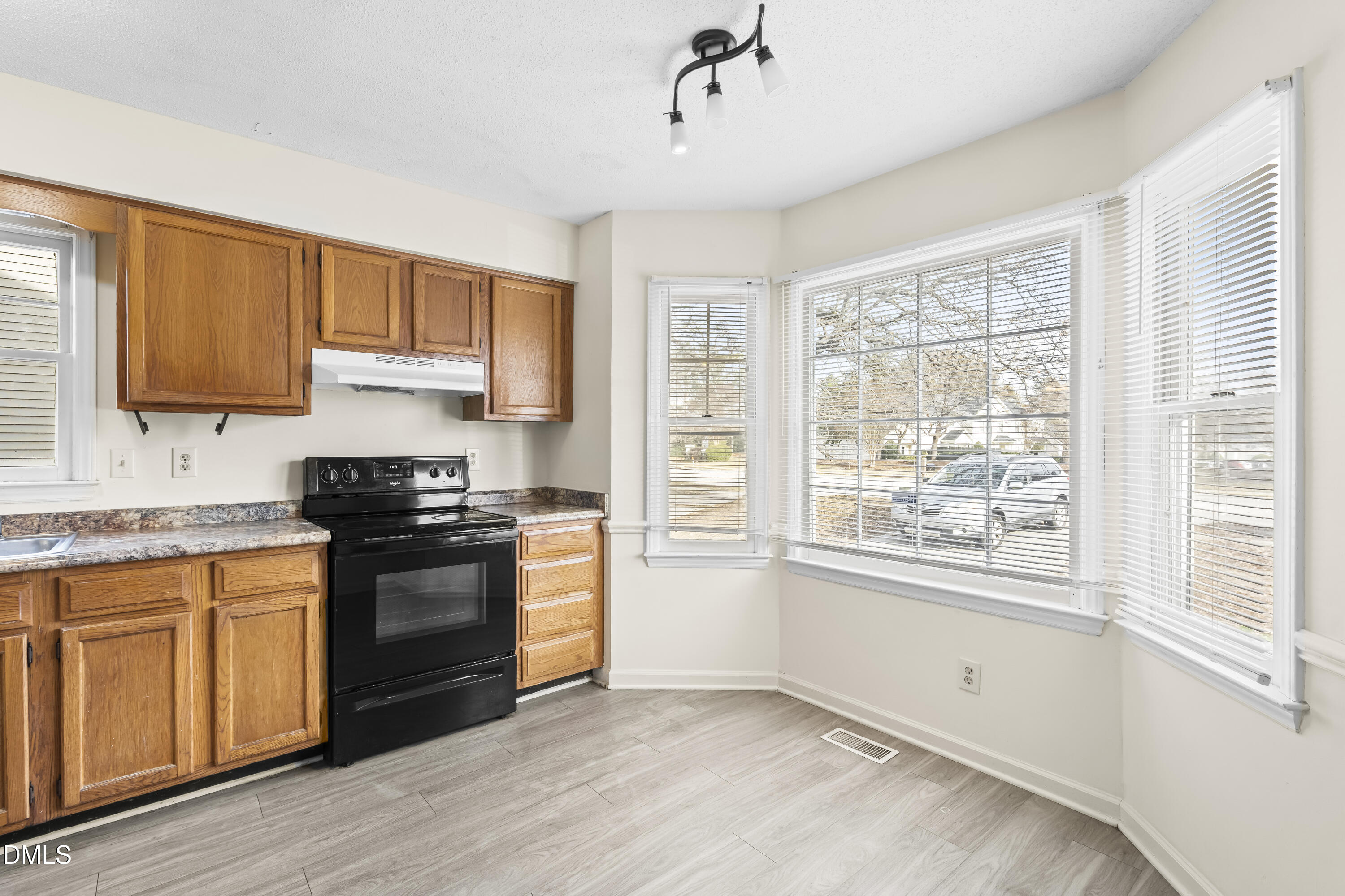 8031 Perry Creek Road Raleigh, NC 27616 - Photo 6 of 28 a kitchen with stainless steel appliances granite countertop a stove a sink and a refrigerator