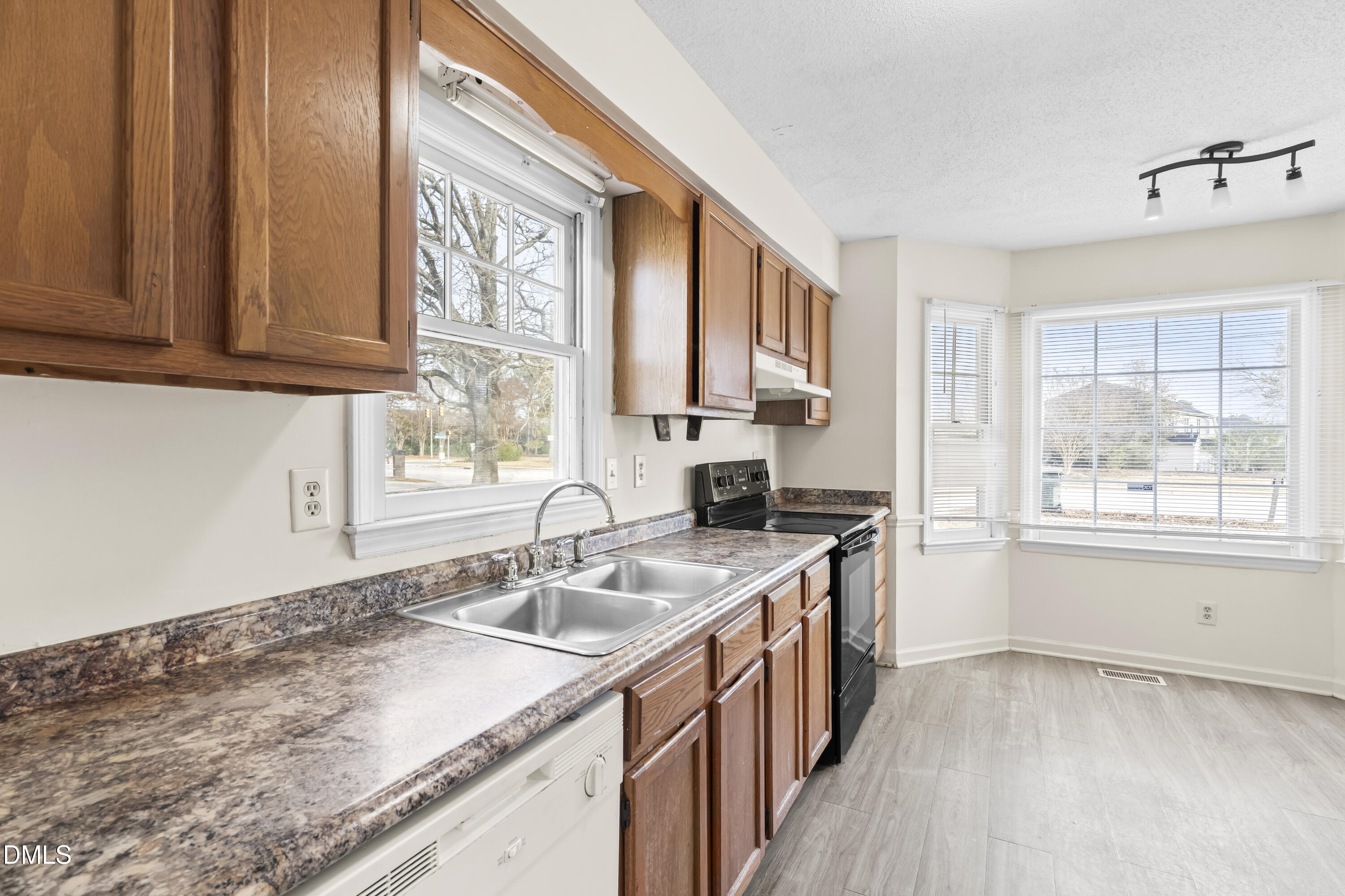 8031 Perry Creek Road Raleigh, NC 27616 - Photo 8 of 28 a kitchen with a sink stove and cabinets