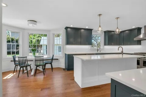 a kitchen with a table chairs sink and window