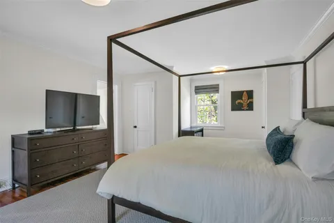 a bedroom with a bed and a flat screen television