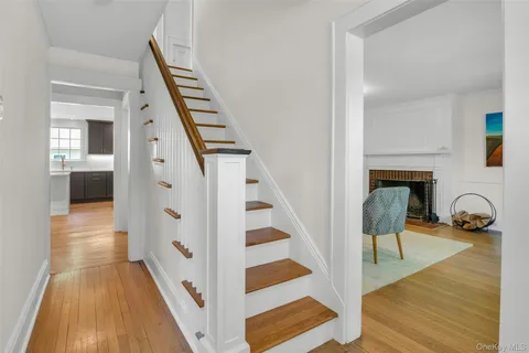 a view of front door with furniture and wooden floor