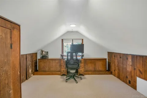 a view of a livingroom with furniture and a window