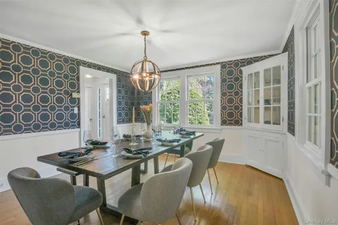 a view of a dining room with furniture wooden floor and chandelier