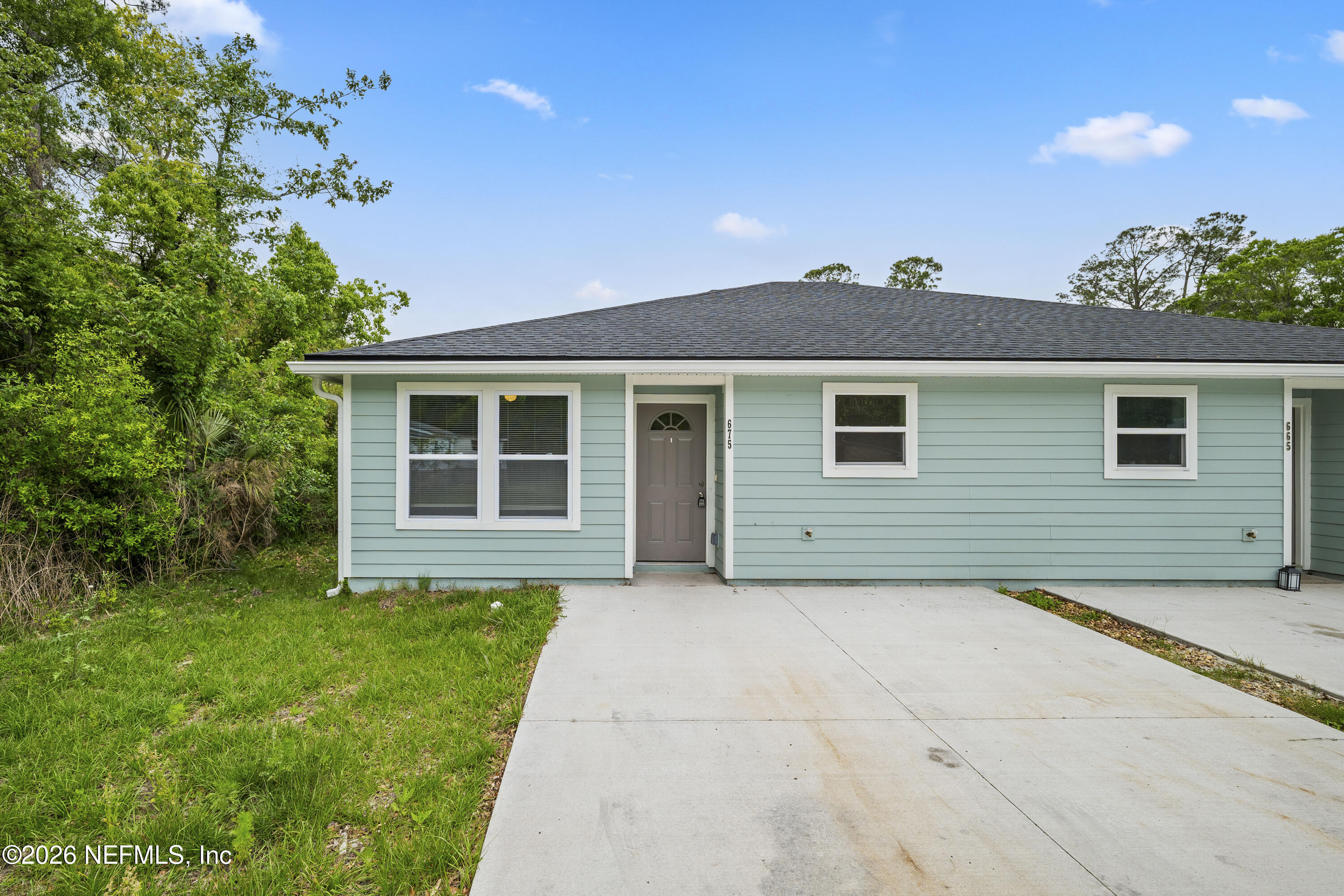 675 Moore Street Baldwin, FL 32234 - Photo 1 of 31 a front view of a house with a yard