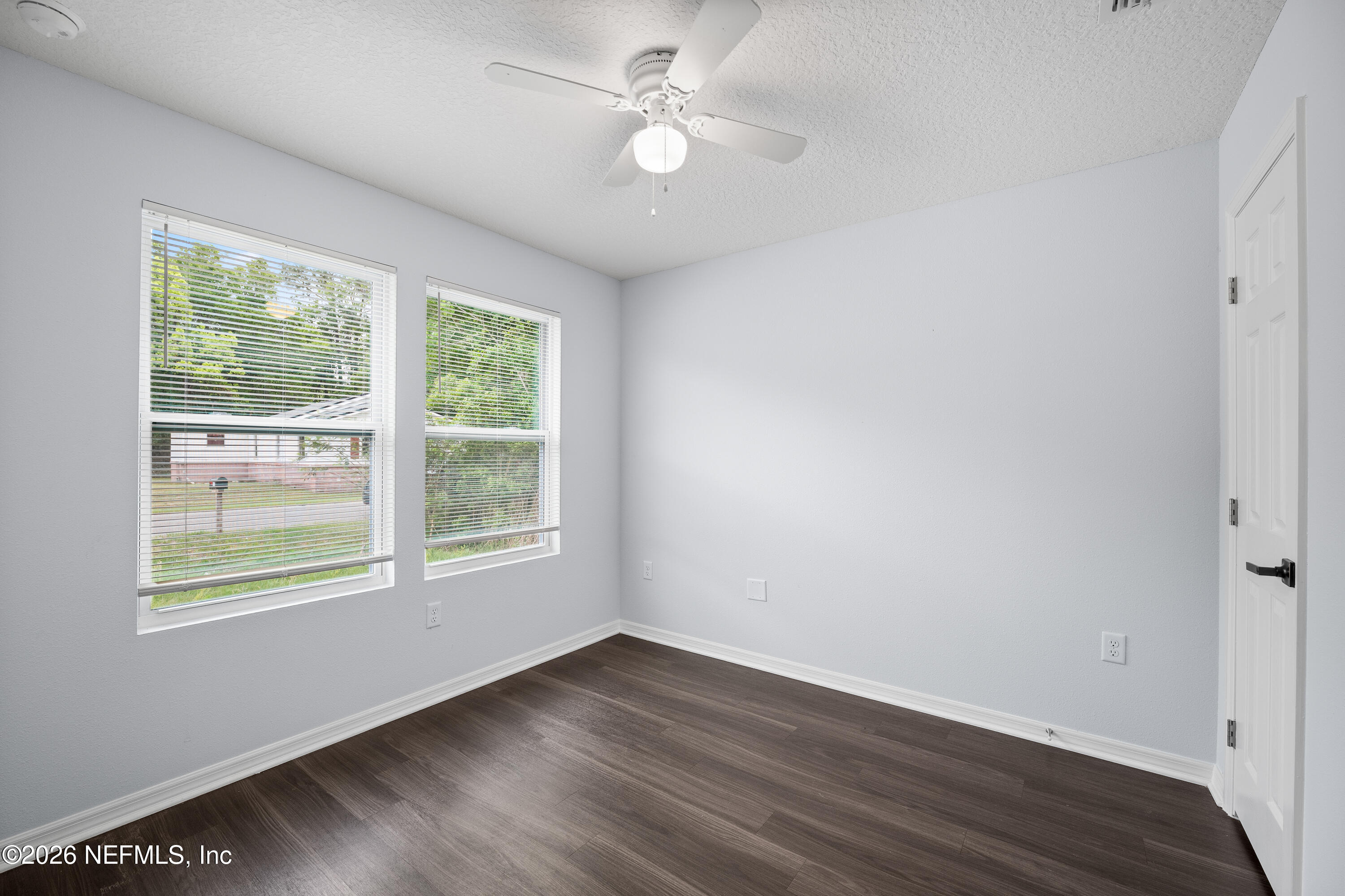 675 Moore Street Baldwin, FL 32234 - Photo 11 of 31 a view of an empty room with wooden floor and a window