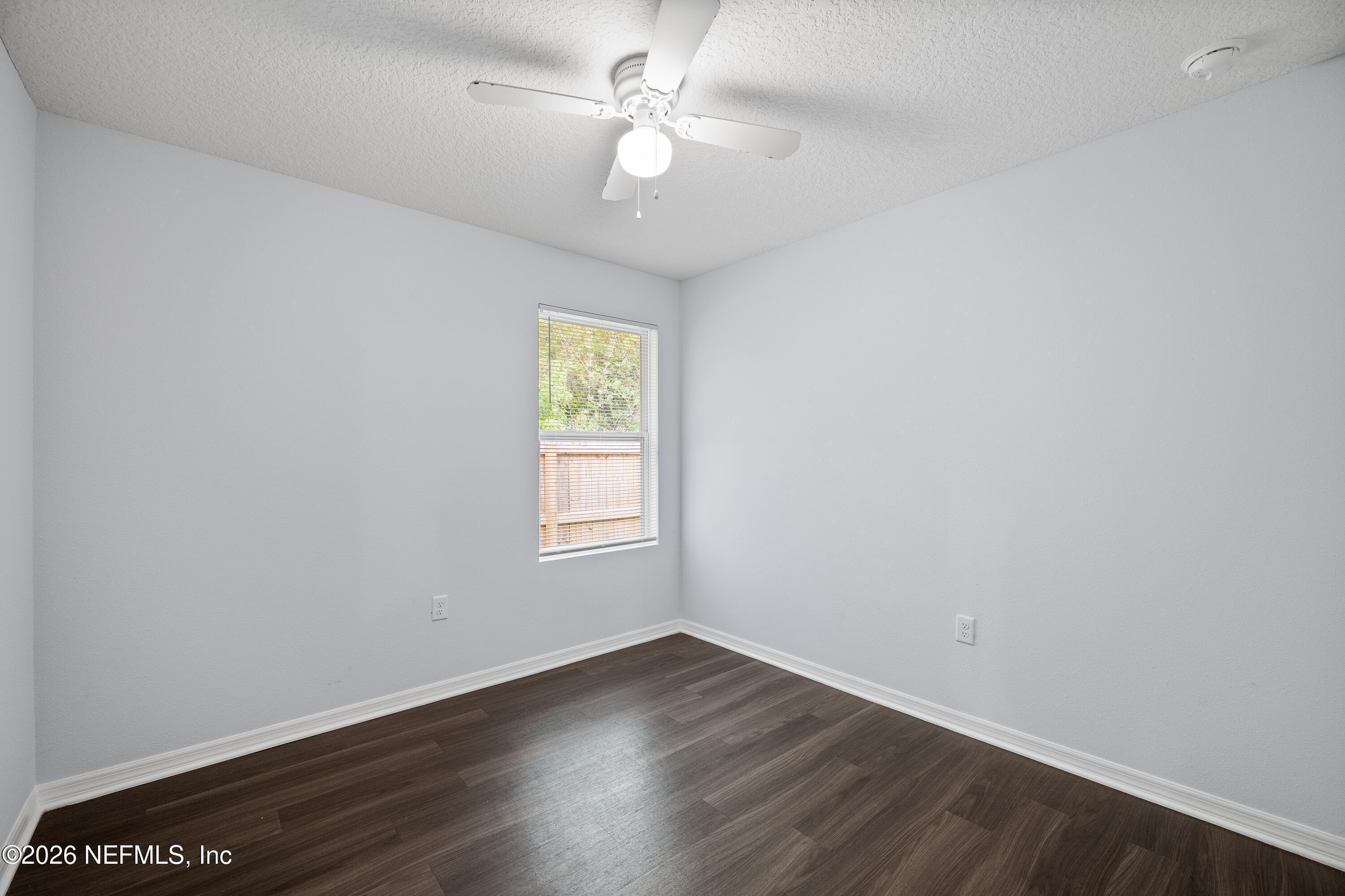 675 Moore Street Baldwin, FL 32234 - Photo 13 of 31 an empty room with a window and wooden floor