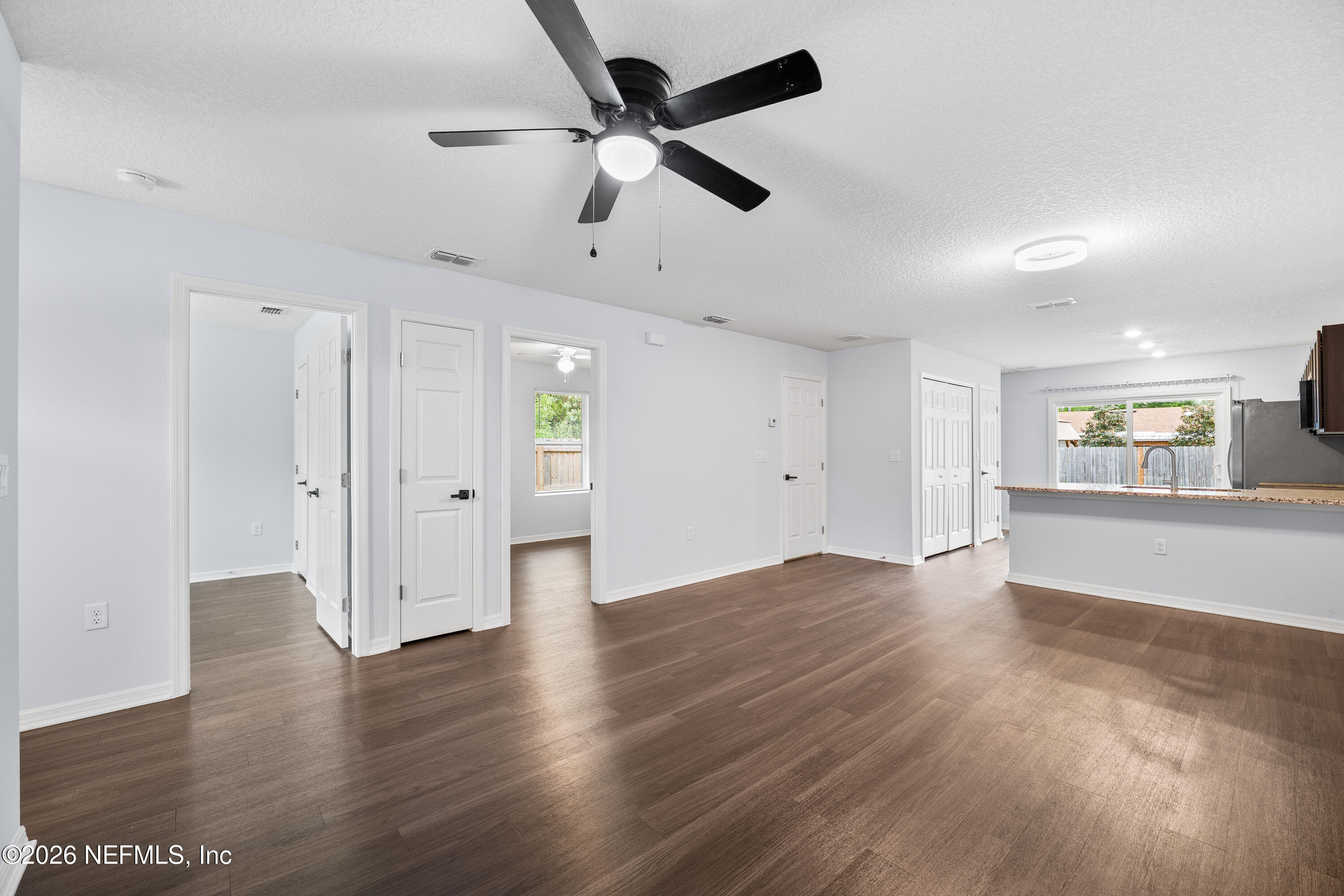 675 Moore Street Baldwin, FL 32234 - Photo 15 of 31 a view of an empty room with wooden floor and a ceiling fan