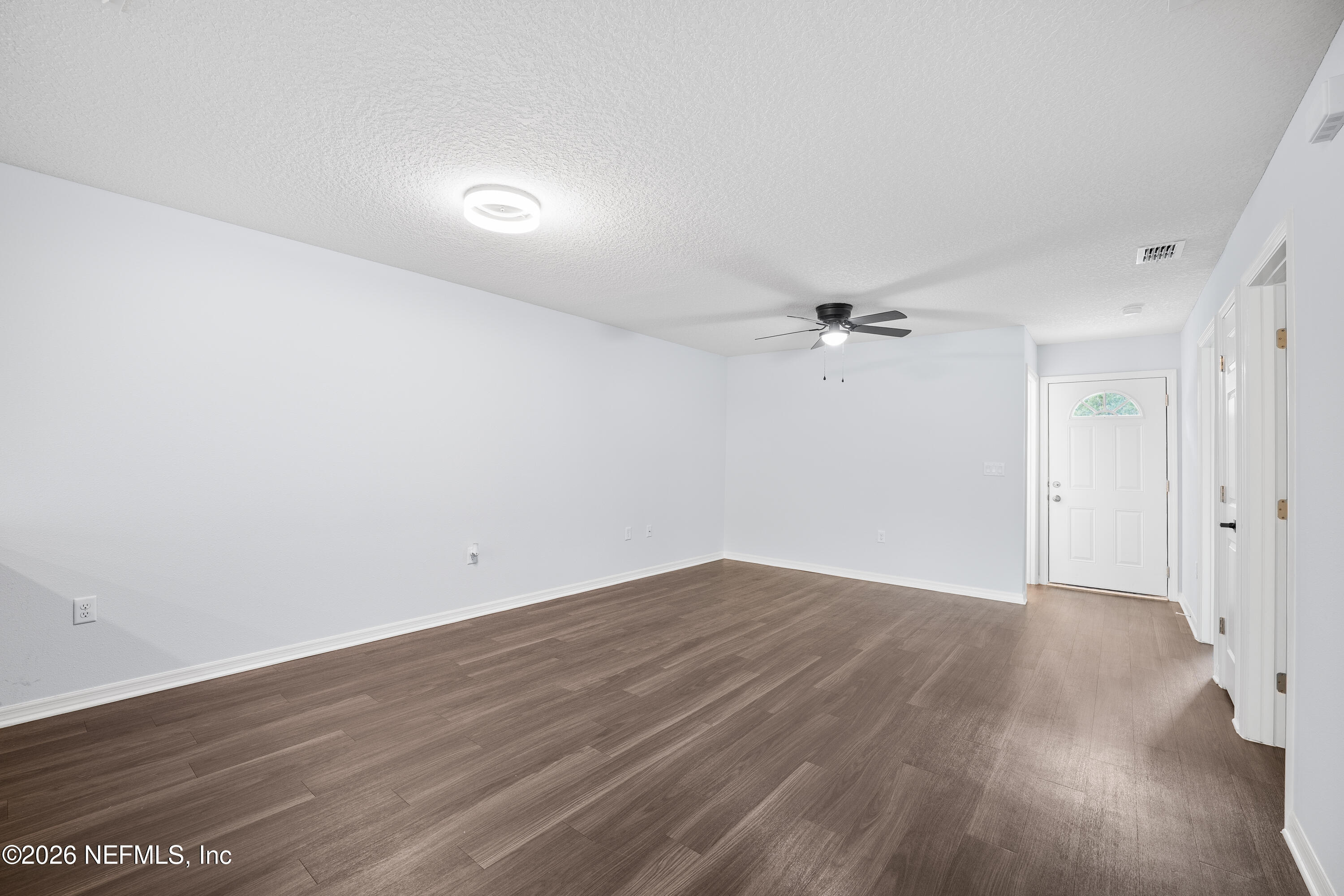 675 Moore Street Baldwin, FL 32234 - Photo 16 of 31 an empty room with wooden floor and fan