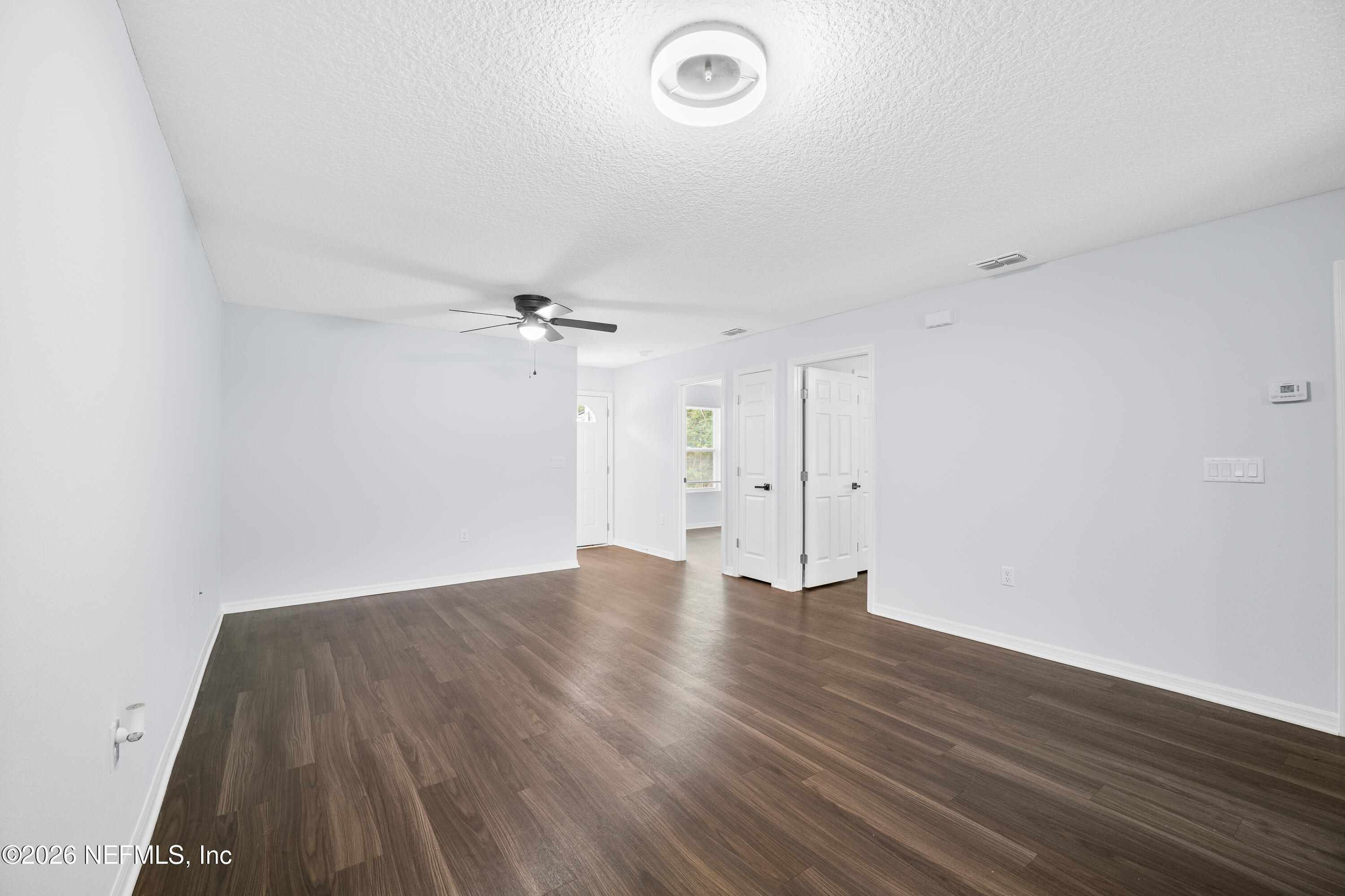 675 Moore Street Baldwin, FL 32234 - Photo 17 of 31 an empty room with wooden floor and windows
