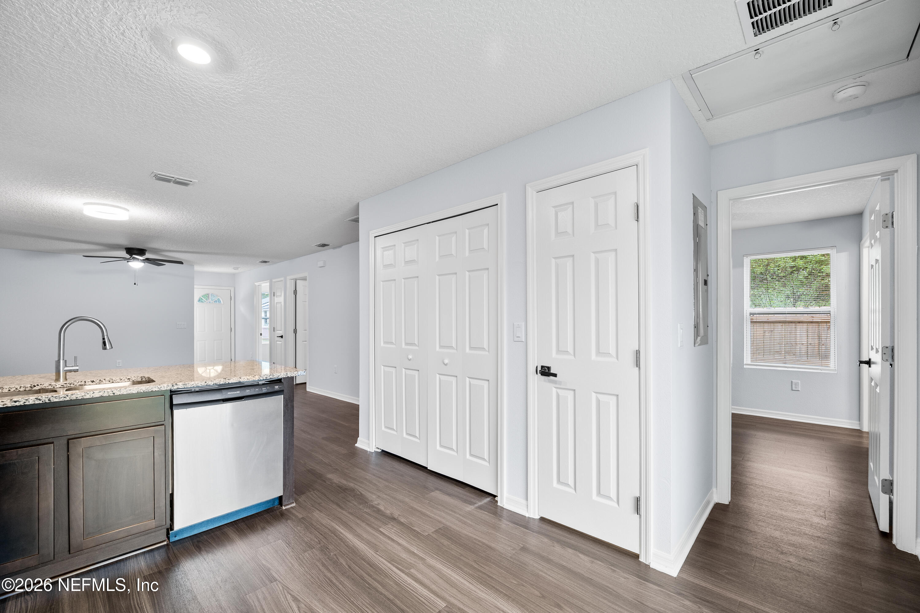 675 Moore Street Baldwin, FL 32234 - Photo 20 of 31 a kitchen with stainless steel appliances granite countertop a sink cabinets and wooden floor