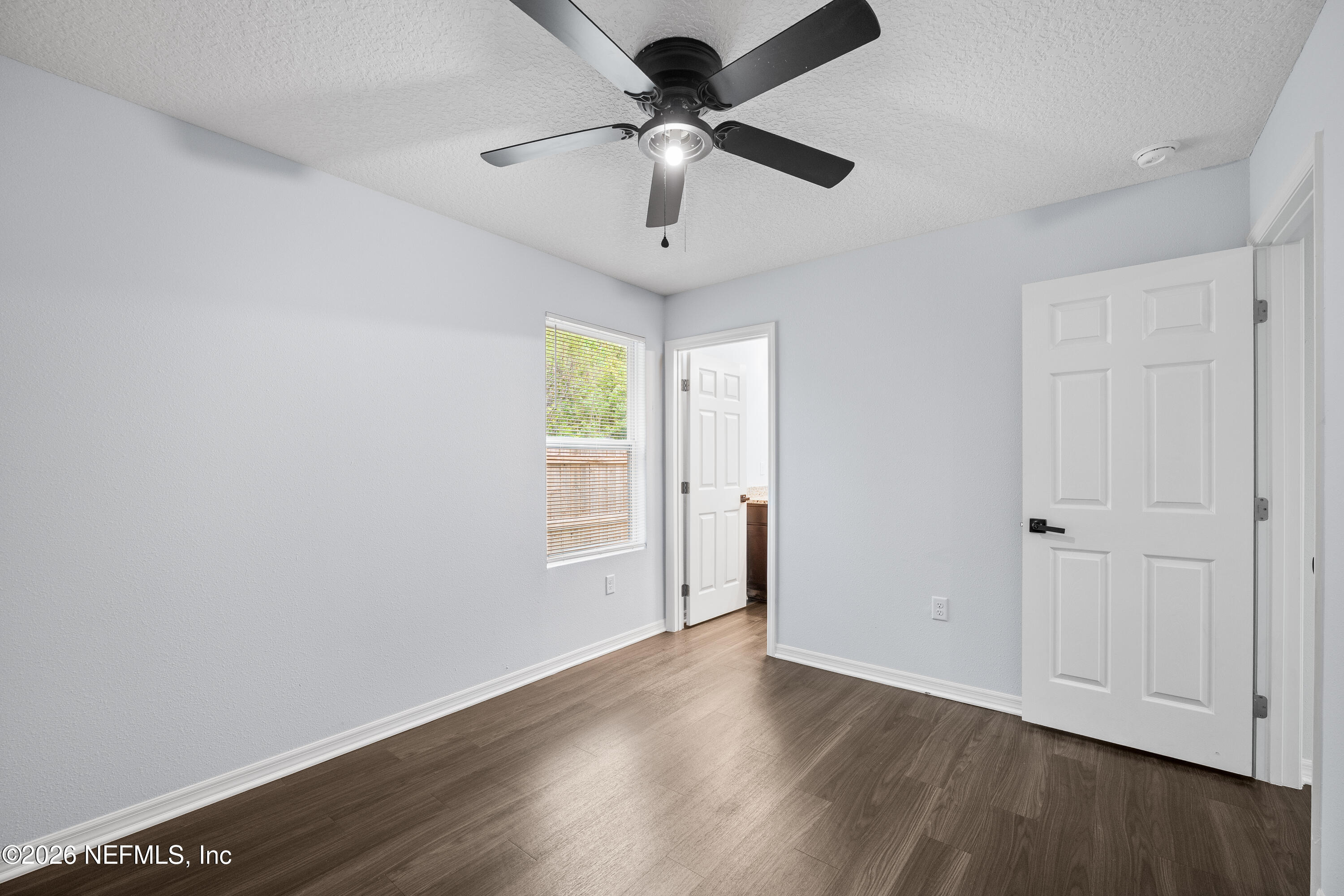 675 Moore Street Baldwin, FL 32234 - Photo 22 of 31 a view of an empty room with wooden floor and a window