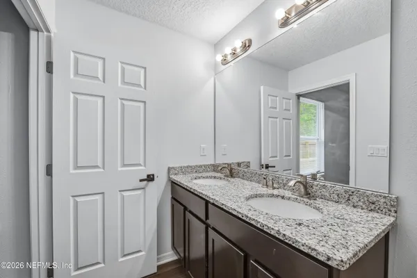 a bathroom with a glass shower door
