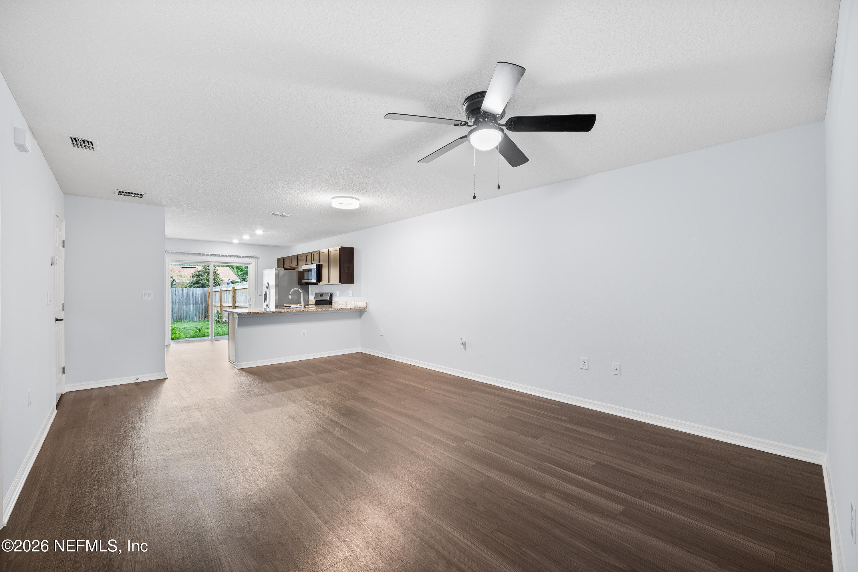 675 Moore Street Baldwin, FL 32234 - Photo 4 of 31 a view of a kitchen with wooden floor a sink and a window