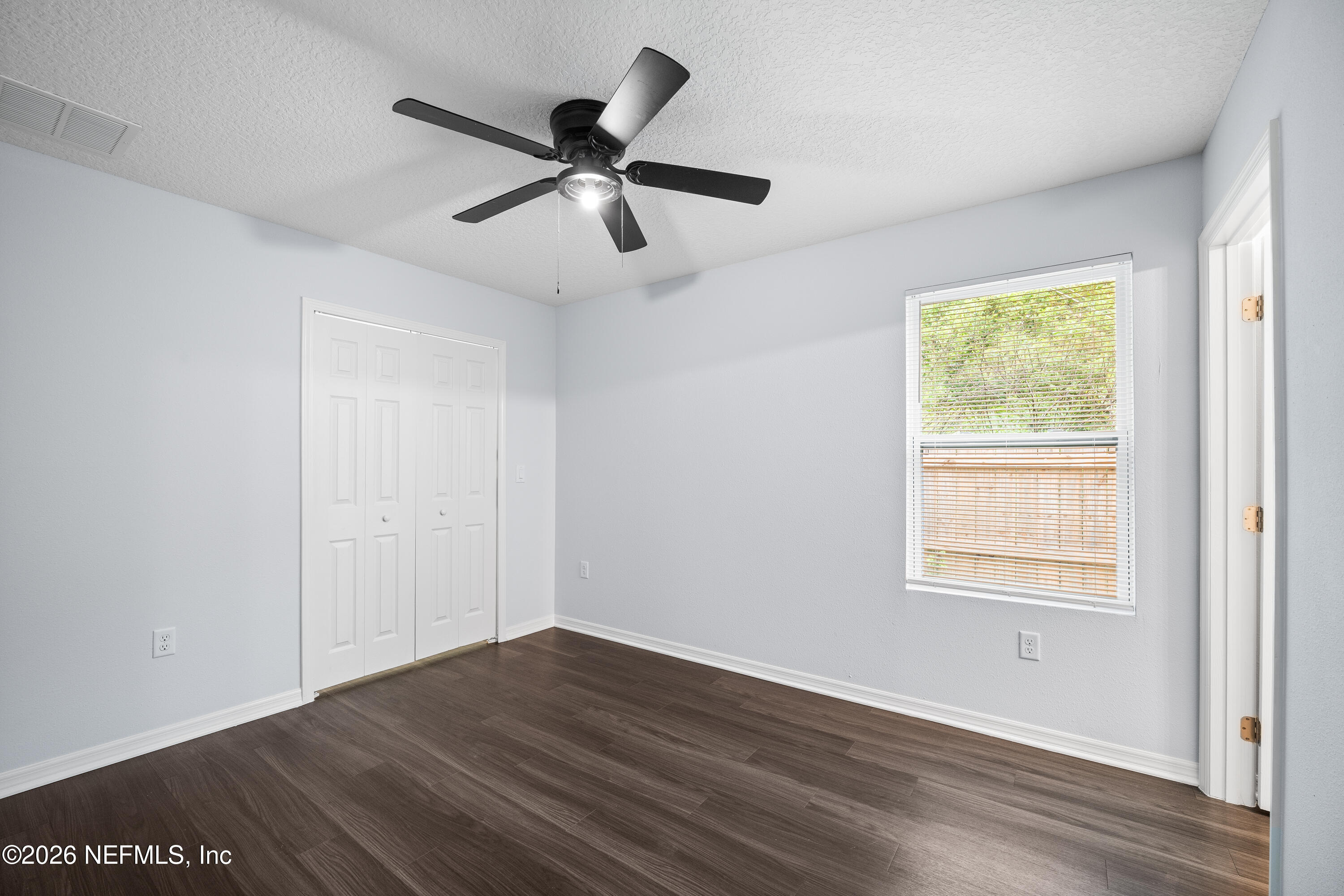 675 Moore Street Baldwin, FL 32234 - Photo 6 of 31 a view of an empty room with wooden floor and a window