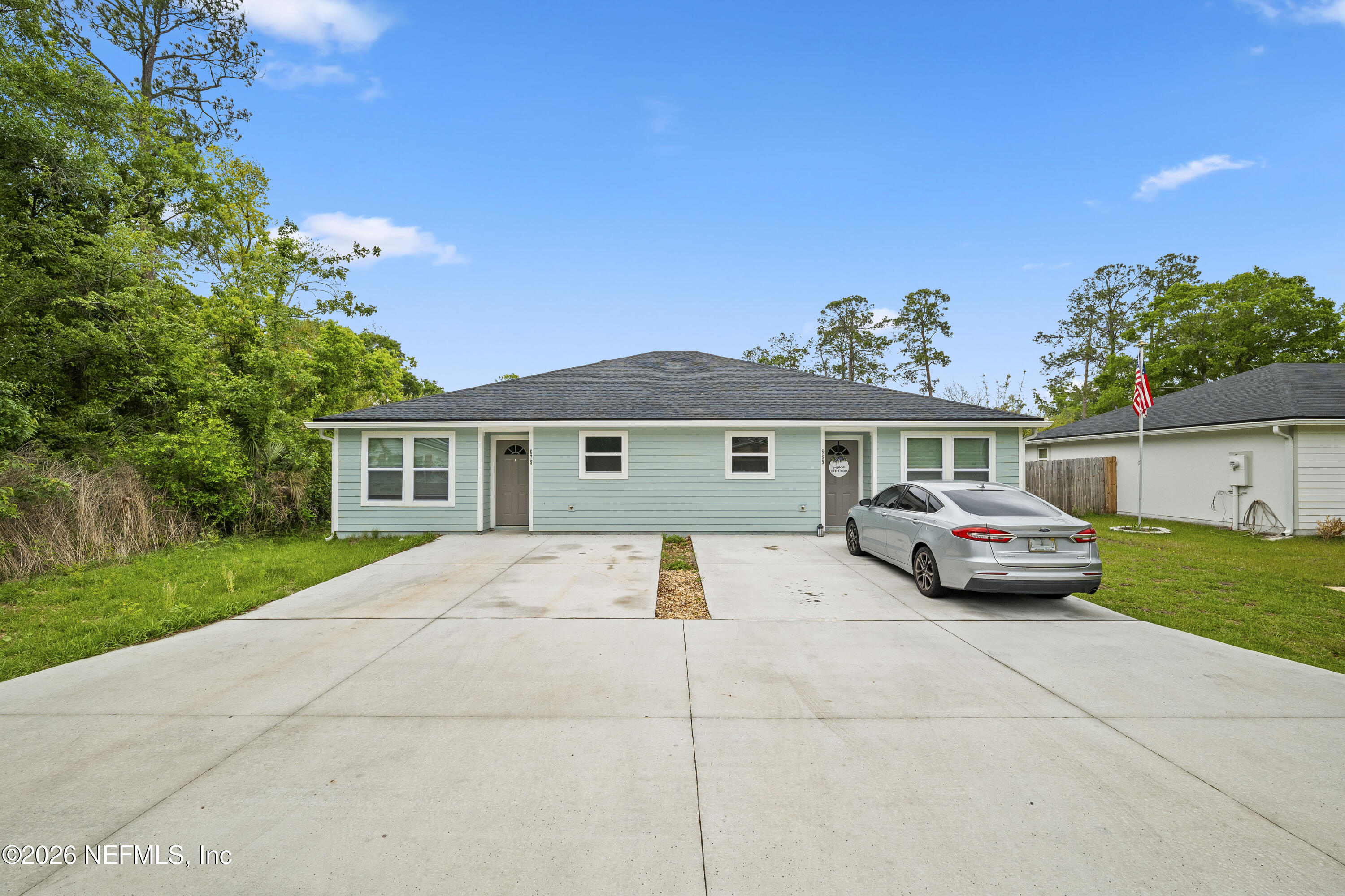 675 Moore Street Baldwin, FL 32234 - Photo 8 of 31 a front view of a house with a yard and garage