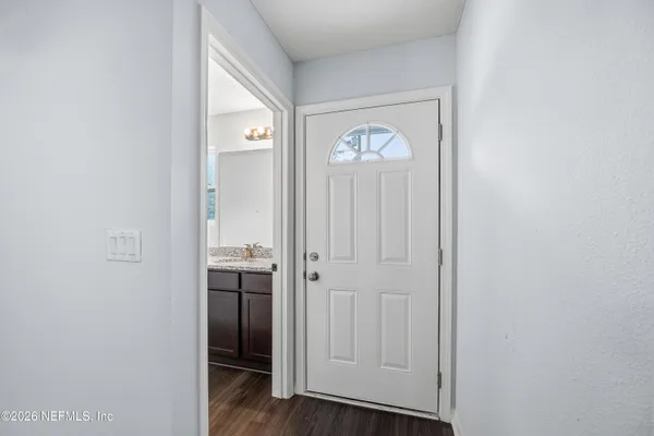 a view of a hallway with wooden floor