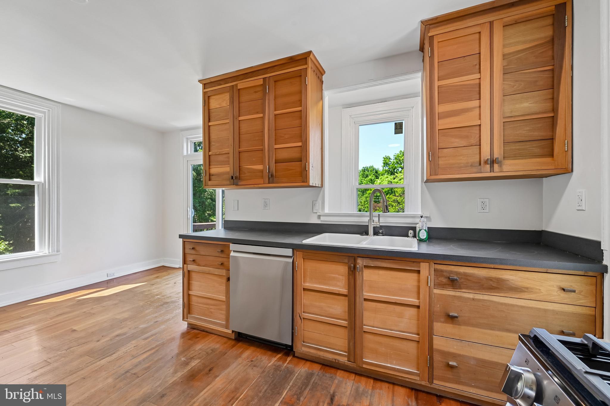5702 Falls Road Baltimore, MD 21209 - Photo 17 of 49 a kitchen with stainless steel appliances granite countertop wooden cabinets a sink and a window