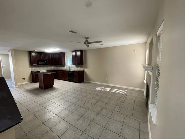 a kitchen with stainless steel appliances a refrigerator and a stove top oven