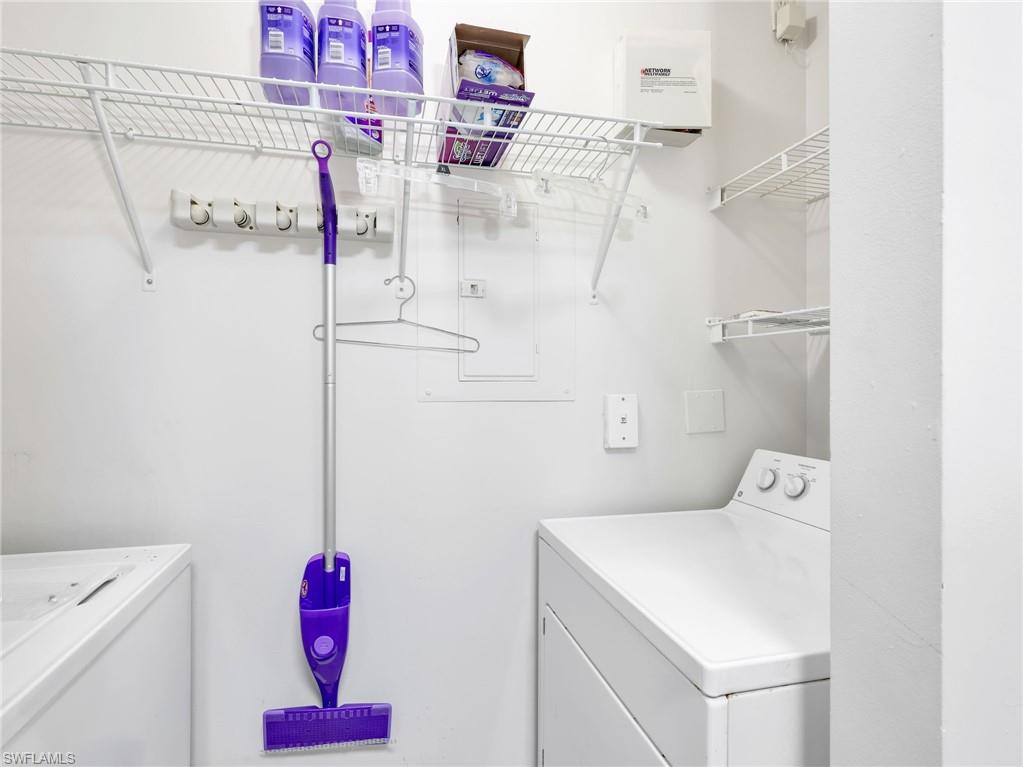1205 Reserve Way, Unit 302 Naples, FL 34105 - Photo 15 of 31 a utility room with a refrigerator and washer