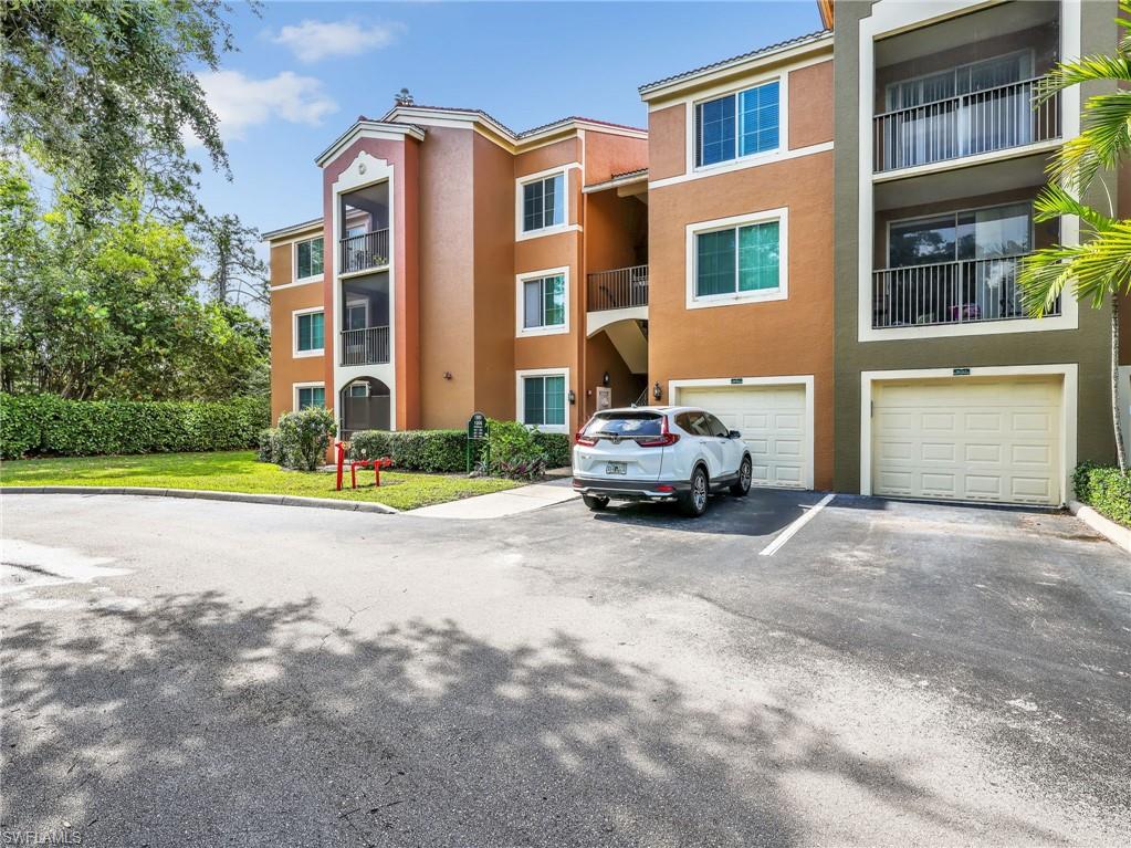 1205 Reserve Way, Unit 302 Naples, FL 34105 - Photo 2 of 31 a building with car parked in front of it