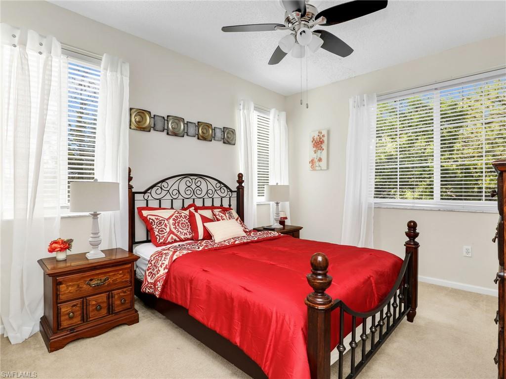 1205 Reserve Way, Unit 302 Naples, FL 34105 - Photo 21 of 31 a bedroom with a bed and a window