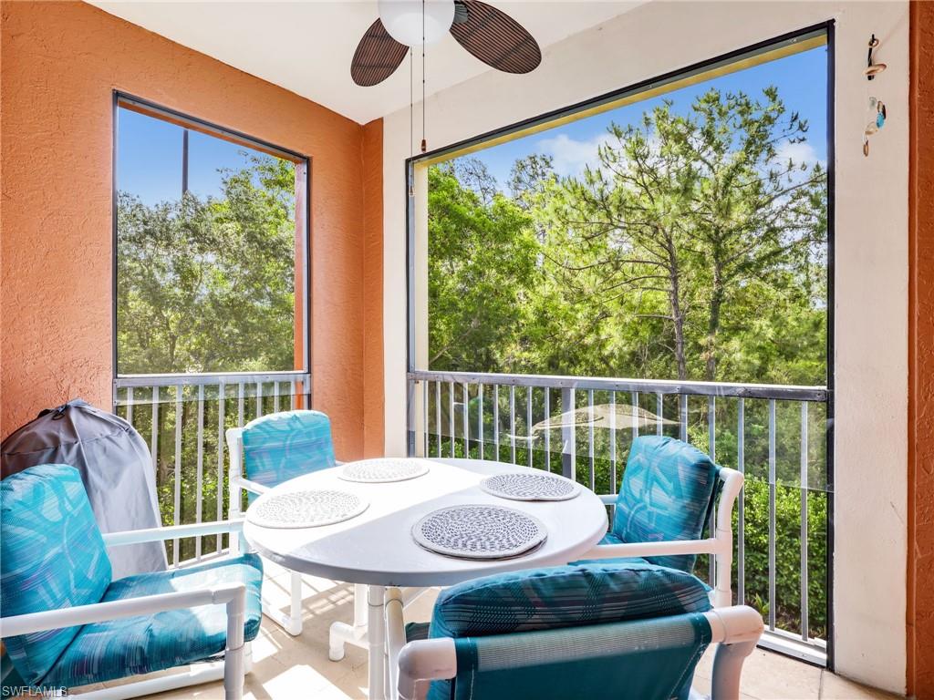 1205 Reserve Way, Unit 302 Naples, FL 34105 - Photo 23 of 31 a balcony with furniture and large windows