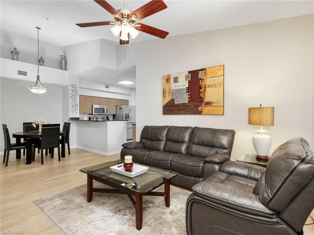 1205 Reserve Way, Unit 302 Naples, FL 34105 - Photo 6 of 31 a living room with furniture and kitchen view