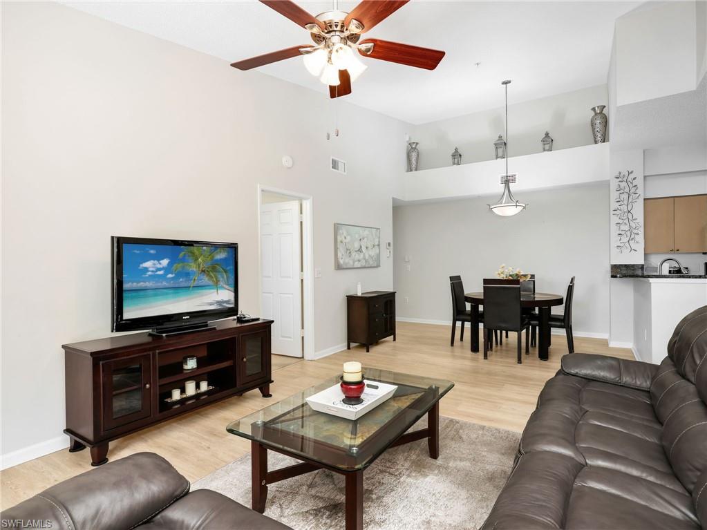 1205 Reserve Way, Unit 302 Naples, FL 34105 - Photo 7 of 31 a living room with furniture a dining table and a piano