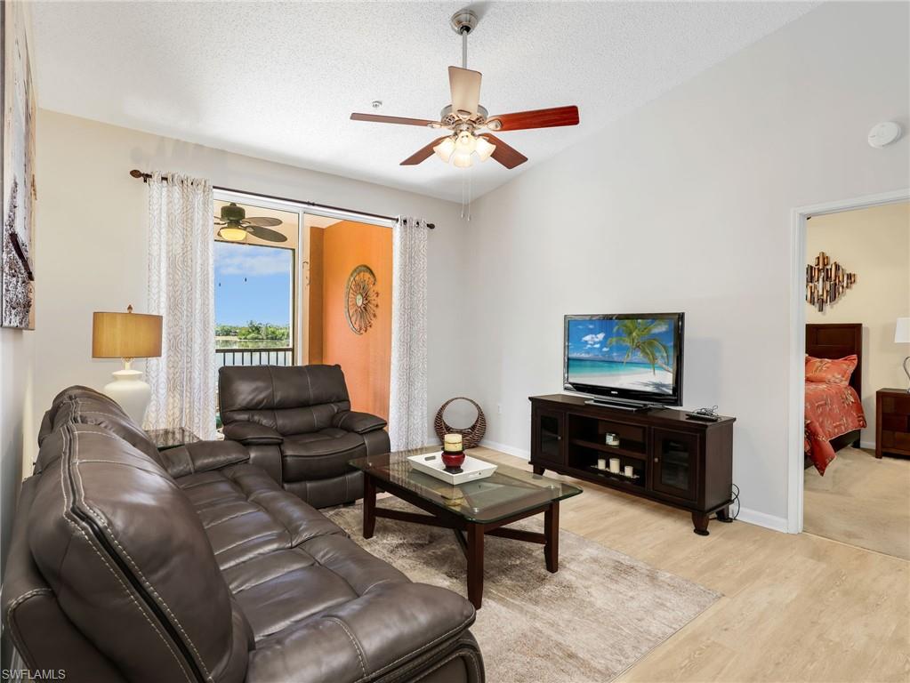 1205 Reserve Way, Unit 302 Naples, FL 34105 - Photo 9 of 31 a living room with furniture and a flat screen tv