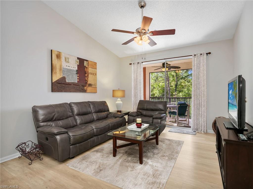 1205 Reserve Way, Unit 302 Naples, FL 34105 - Photo 10 of 31 a living room with furniture a ceiling fan and a window