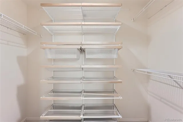 a view of walk in closet with empty racks