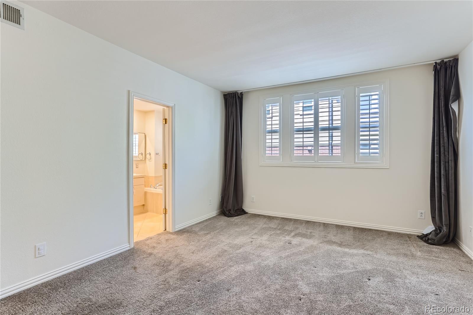 15 Jackson Street, Unit A Denver, CO 80206 - Photo 9 of 17 an empty room with windows