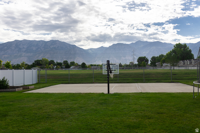1204 North 3020th Street West Provo, UT 84601 - Photo 5 of 35 Expansive lawn area featuring a concrete sports court with a basketball hoop
