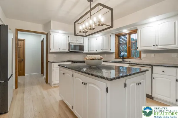 a kitchen with stainless steel appliances granite countertop a sink and cabinets