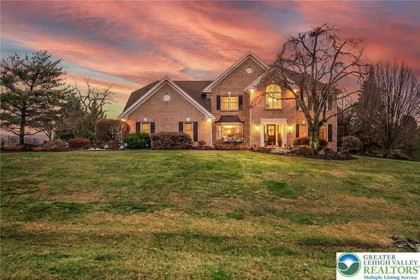 a front view of house with yard and green space
