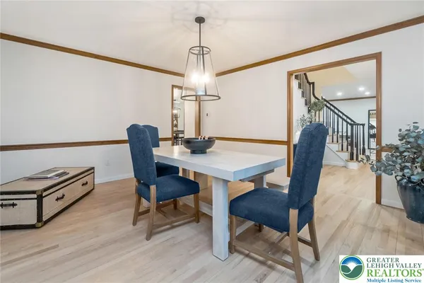 a dining room with furniture a chandelier and wooden floor