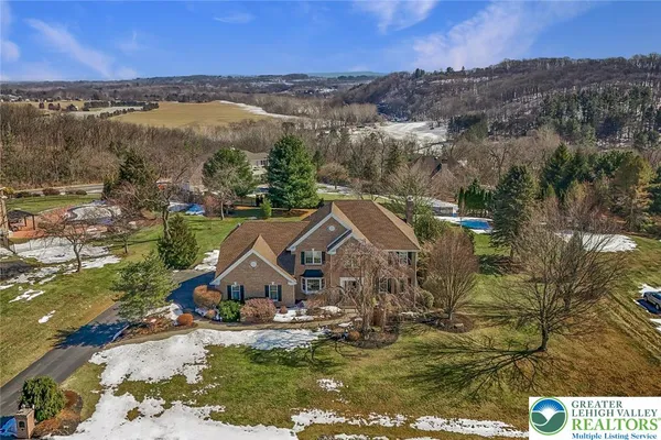 an aerial view of a house with a yard