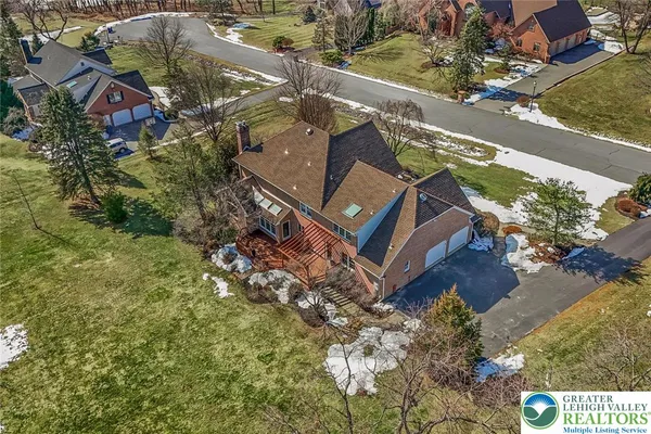an aerial view of a house with a yard