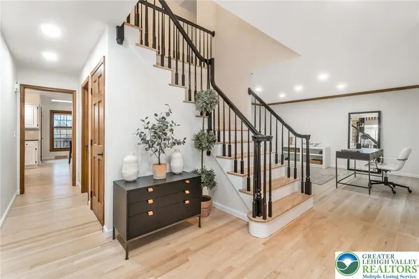 a view of entryway and hall with wooden floor