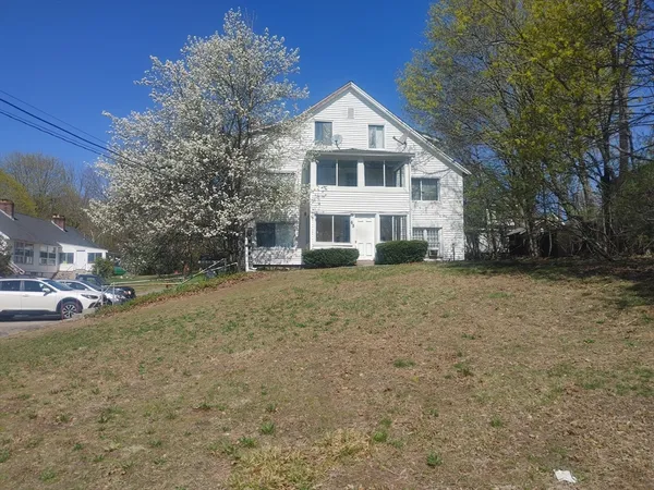 a front view of a house with a yard