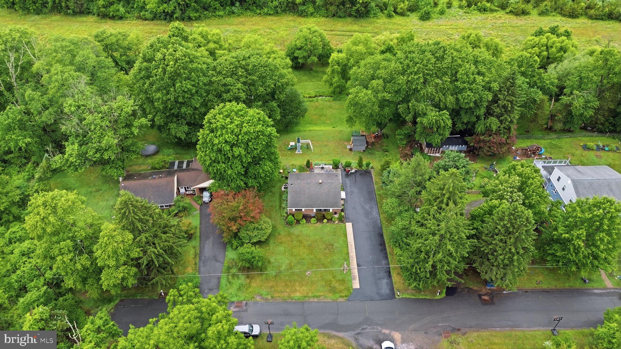 20 Poplar Road Ringoes, NJ 08551 - Photo 39 of 44 Lush greenery surrounds a cozy home.
